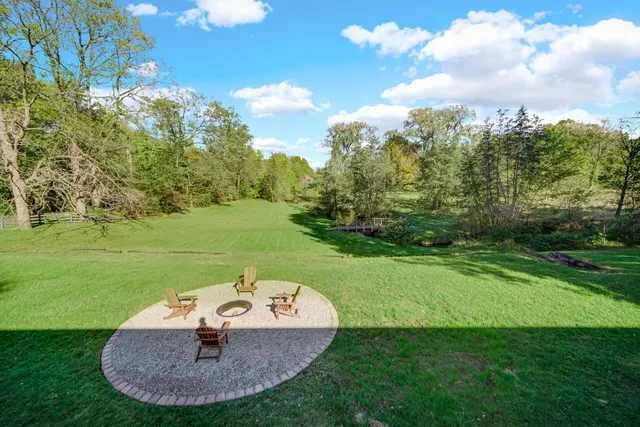 a backyard of a house with table and chairs
