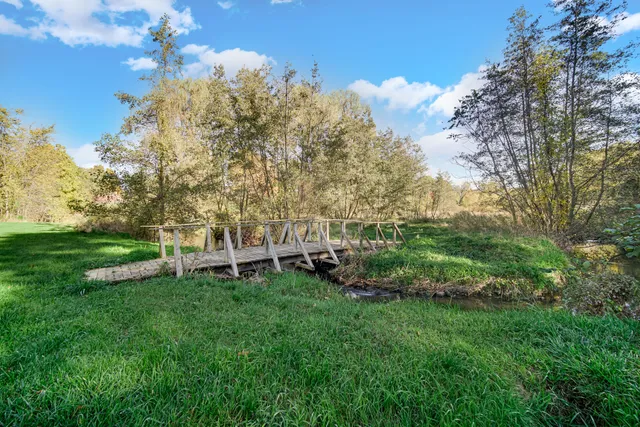 a view of a backyard with sitting area and garden
