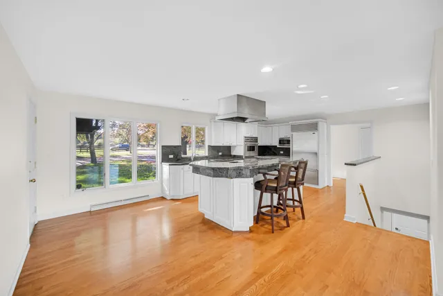 a kitchen with stainless steel appliances a stove a sink a microwave a refrigerator and cabinets