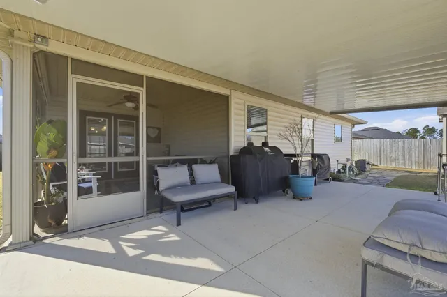 a building outdoor space with patio furniture and potted plants