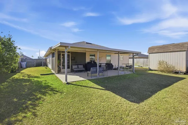 a view of a house with backyard porch and garden