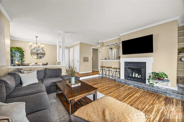 a living room with furniture fireplace and flat screen tv