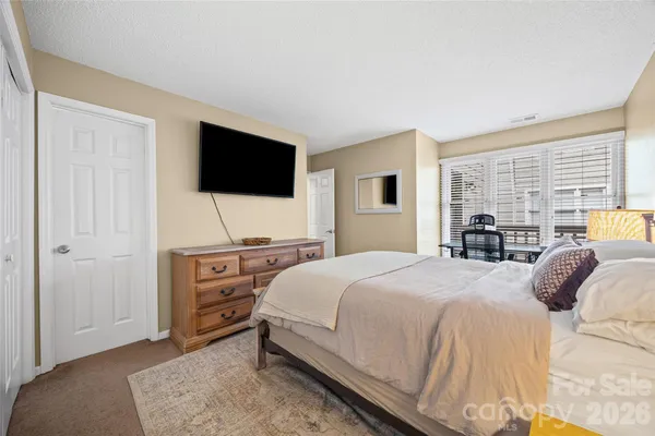 a bedroom with a large bed and a large window