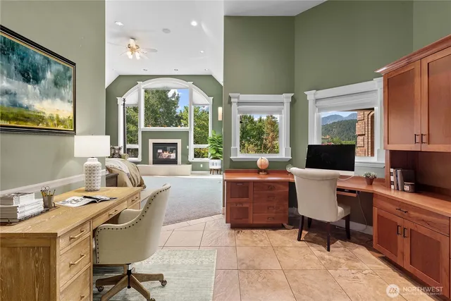 a work room with furniture a window and a fireplace