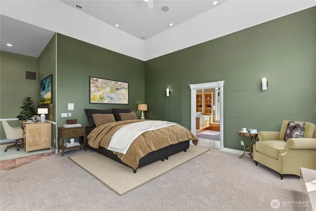 a spacious bedroom with a bed and a couch