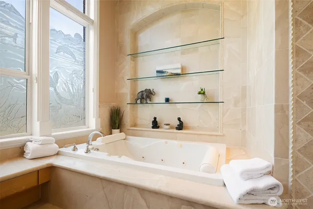 a bathroom with a granite countertop sink and a bathtub
