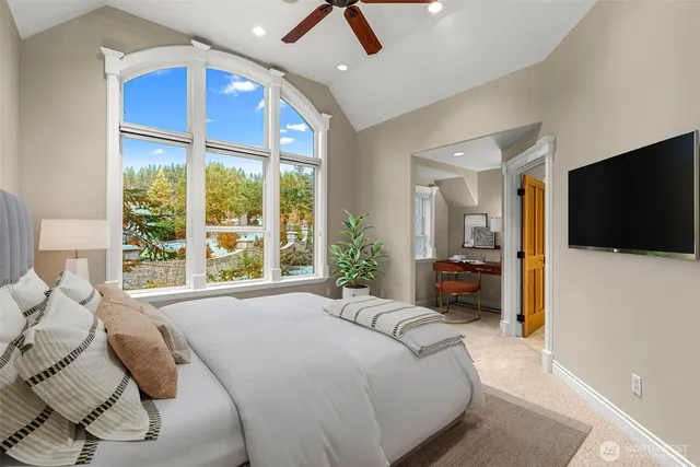 a bedroom with a bed and a television