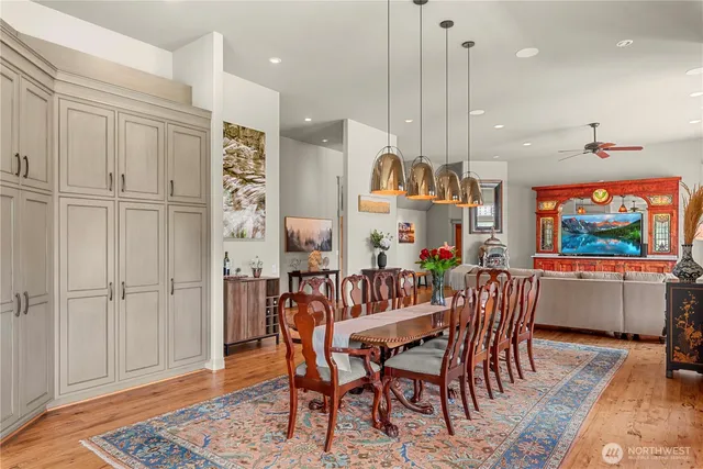 a view of a a dining room with furniture window and wooden floor