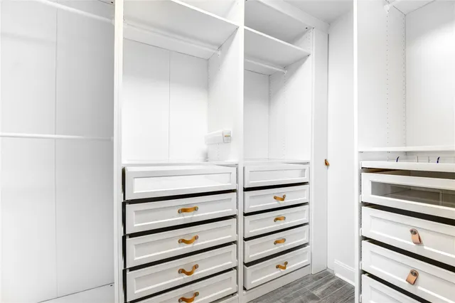 a view of walk in closet with empty racks