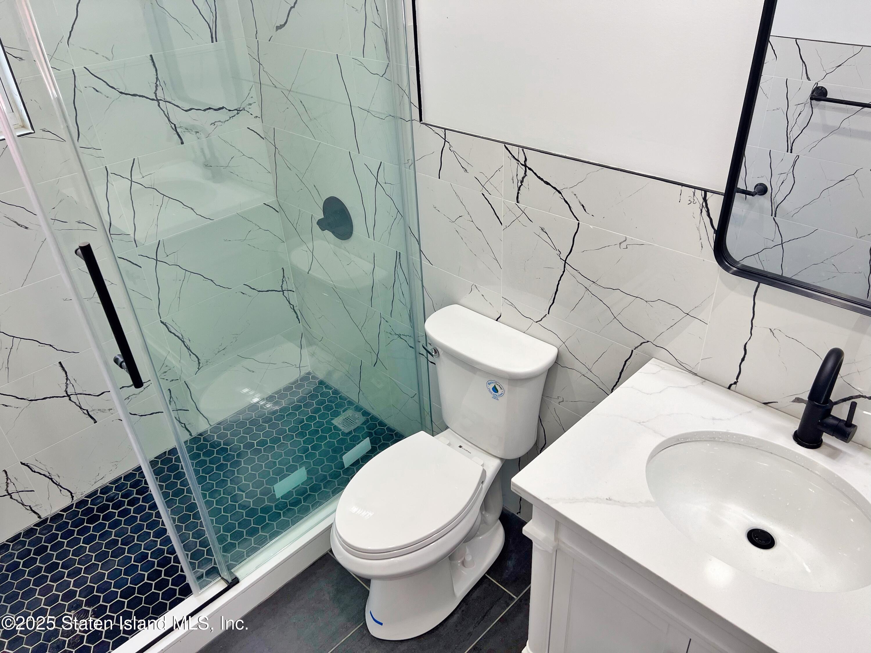 32 Remsen Street Staten Island, NY 10304 - Photo 13 of 41 a white toilet sitting next to a bathroom sink