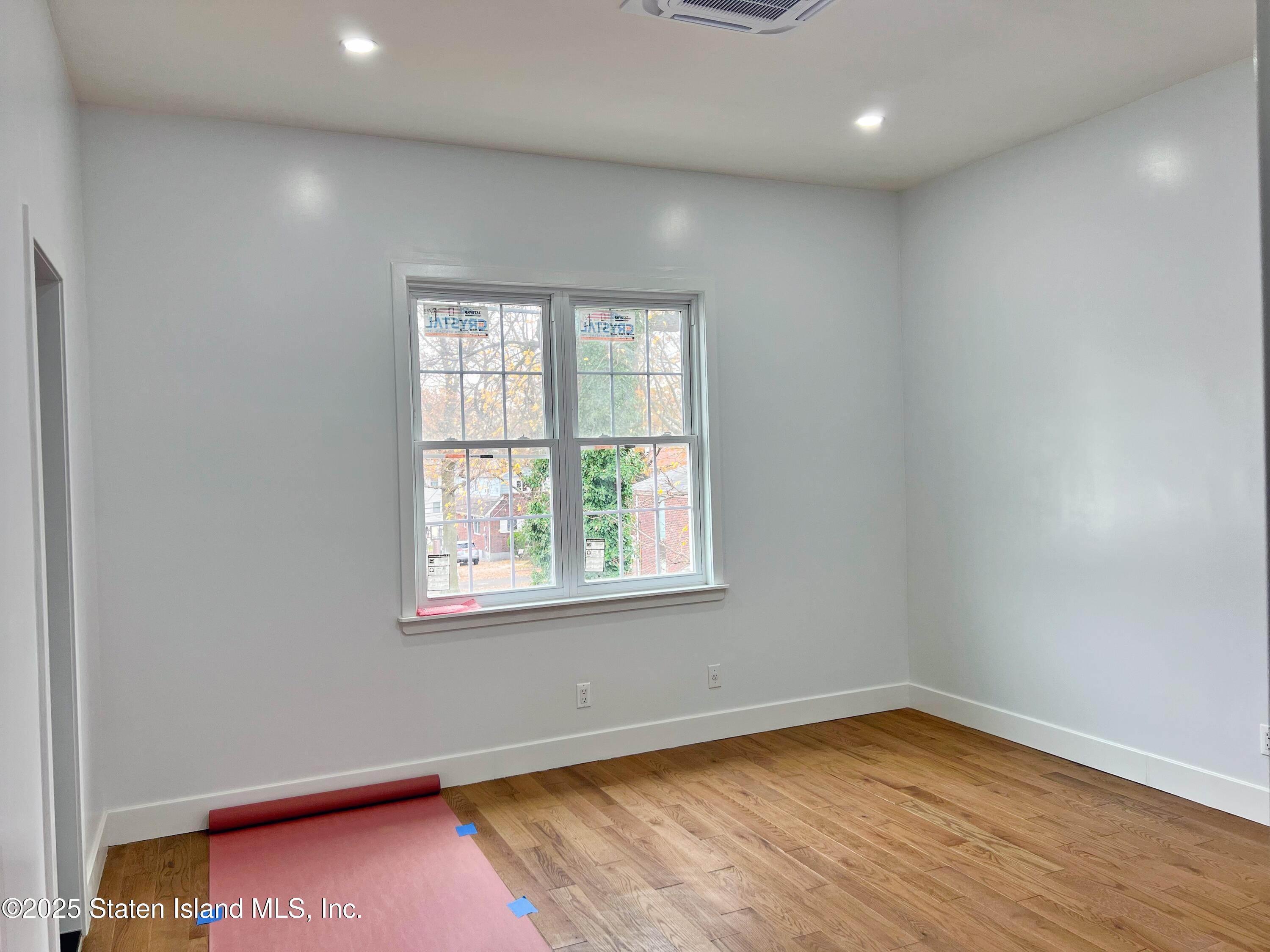 32 Remsen Street Staten Island, NY 10304 - Photo 21 of 41 an empty room with wooden floor and windows