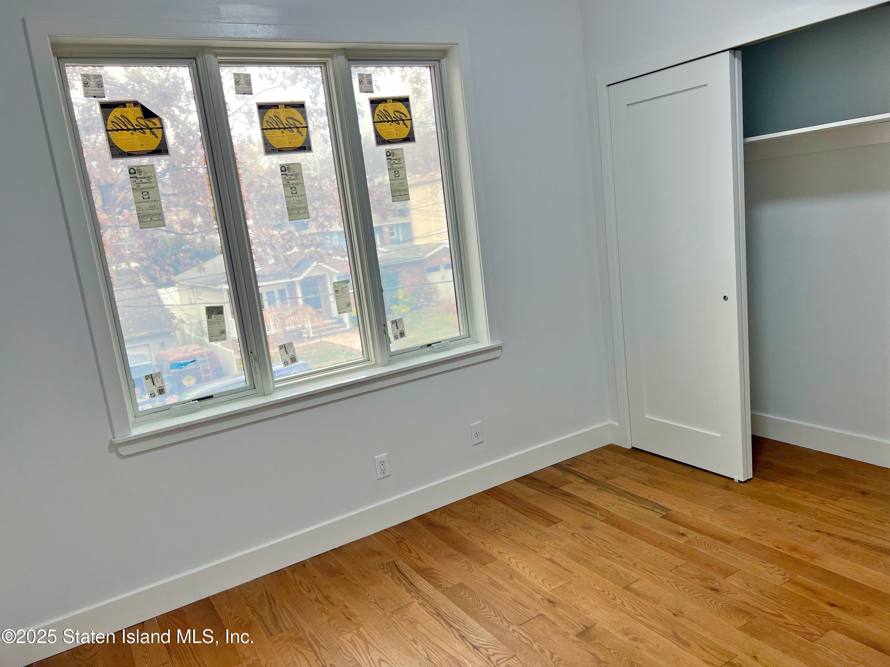 32 Remsen Street Staten Island, NY 10304 - Photo 25 of 41 a view of an empty room with window and wooden floor