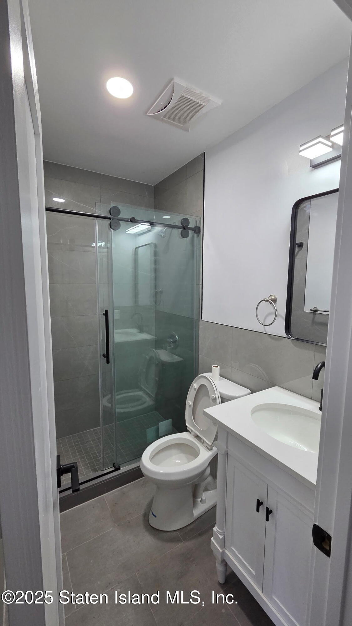 32 Remsen Street Staten Island, NY 10304 - Photo 34 of 41 a white toilet sitting next to a bathroom sink