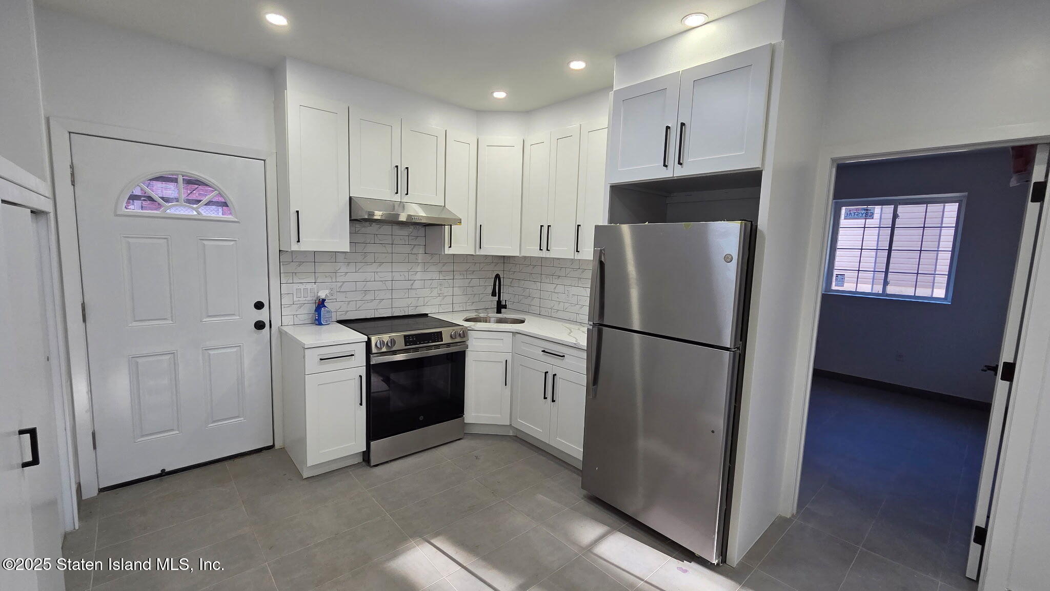 32 Remsen Street Staten Island, NY 10304 - Photo 35 of 41 a kitchen with stainless steel appliances granite countertop a refrigerator sink and cabinets