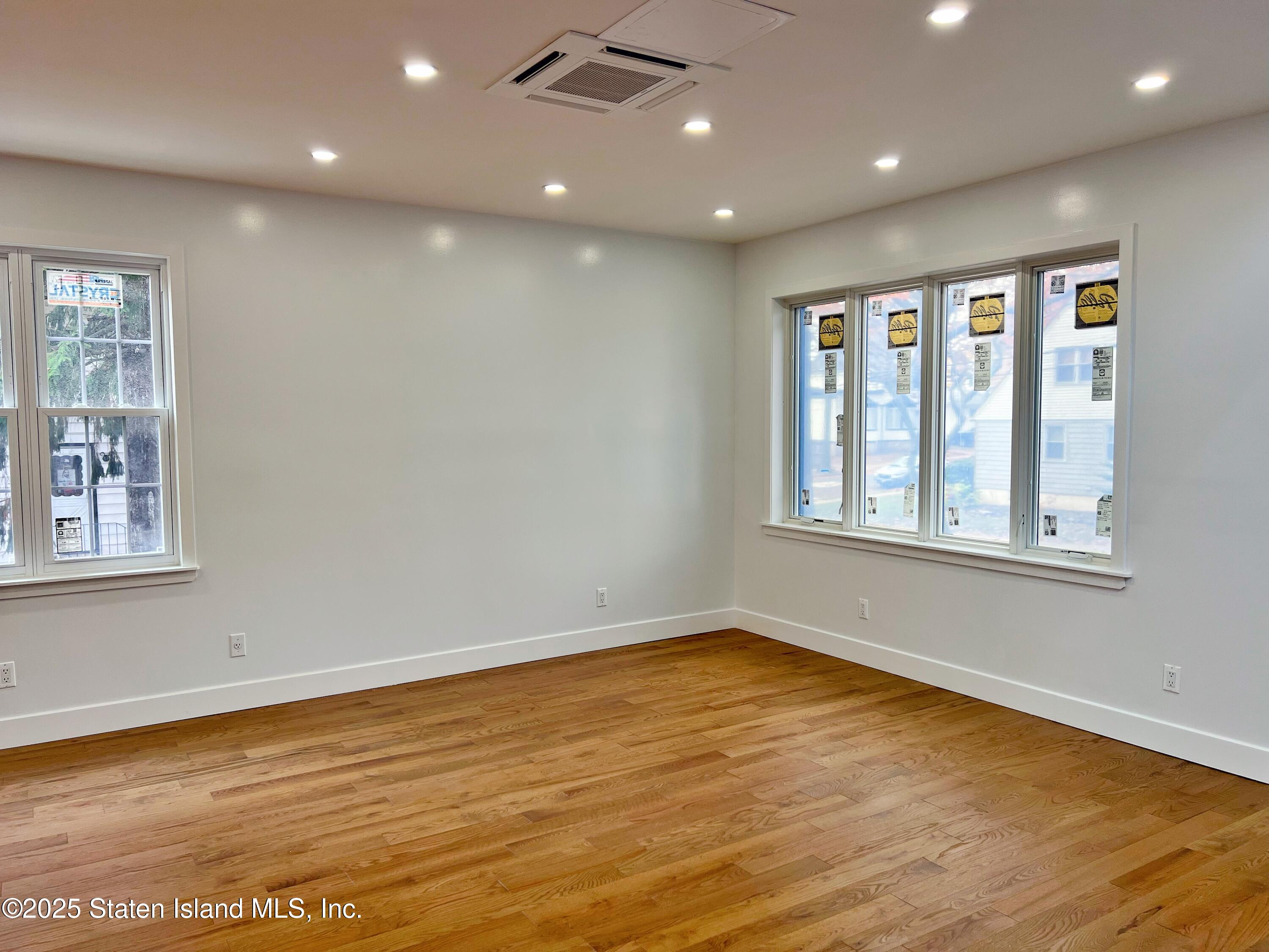 32 Remsen Street Staten Island, NY 10304 - Photo 6 of 41 a view of an empty room with wooden floor and a window