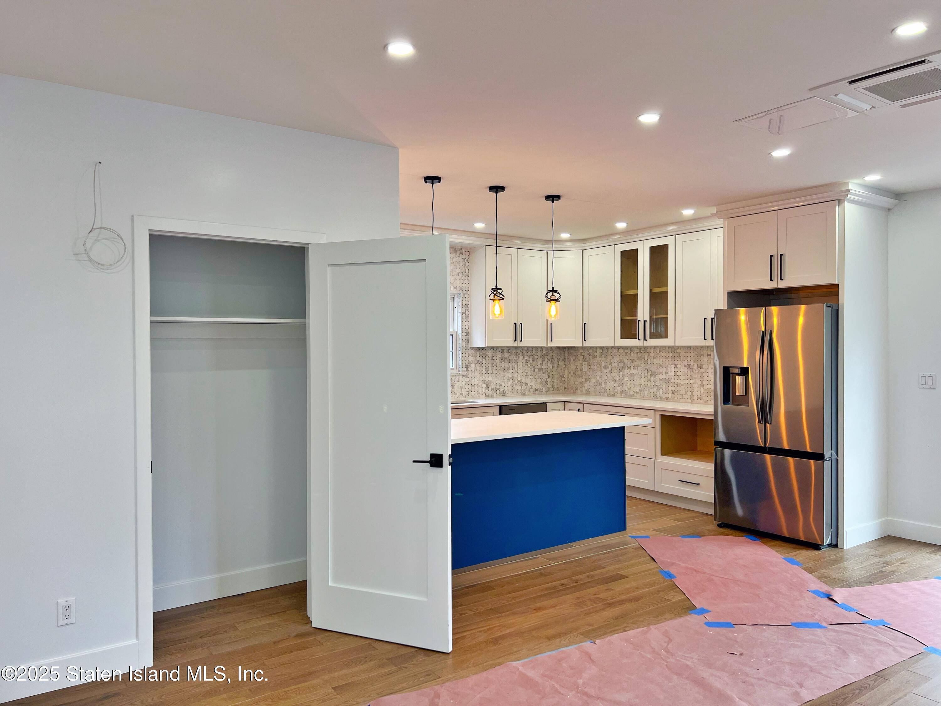 32 Remsen Street Staten Island, NY 10304 - Photo 7 of 41 a kitchen with stainless steel appliances kitchen island granite countertop a refrigerator and a sink