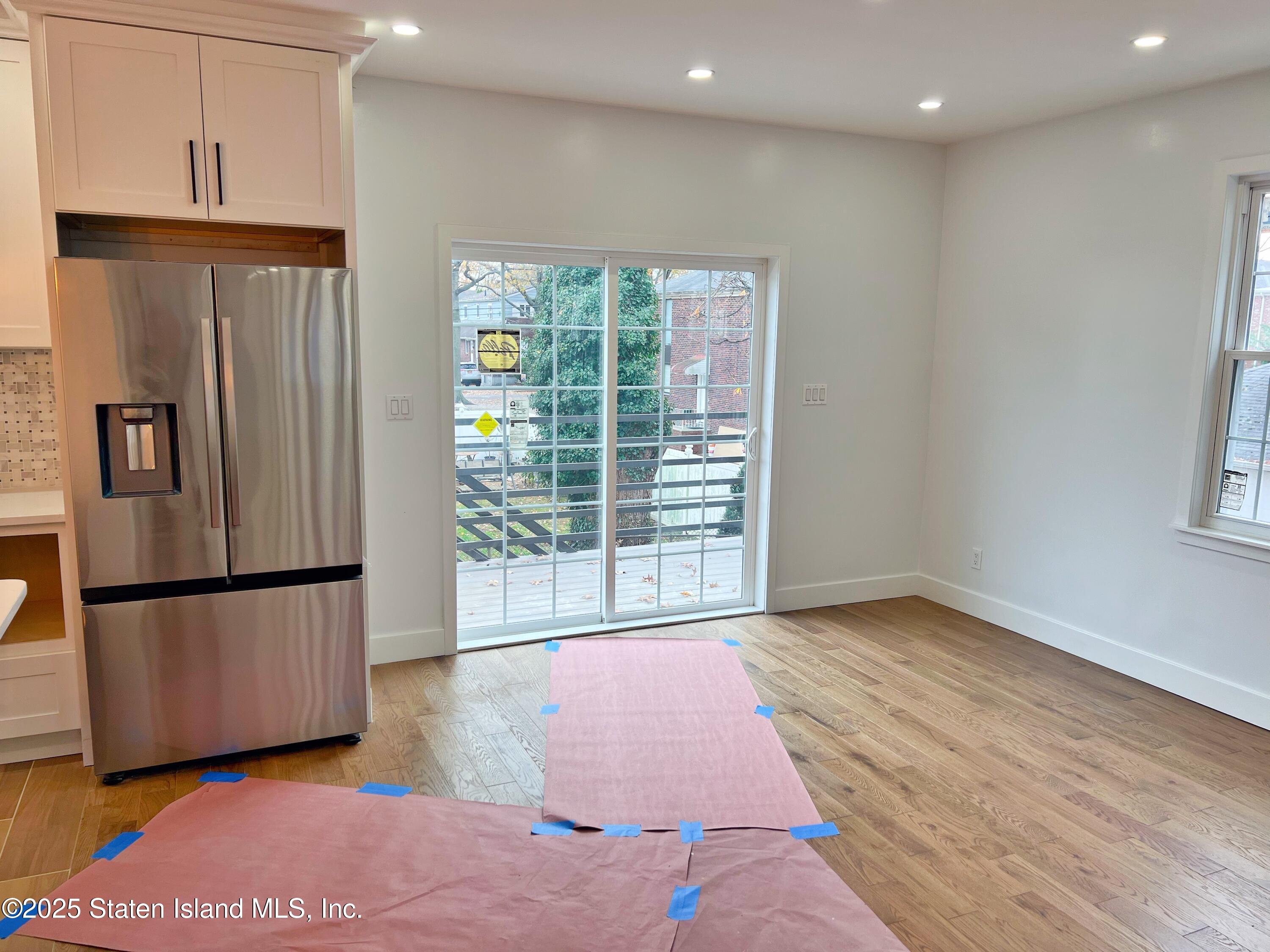 32 Remsen Street Staten Island, NY 10304 - Photo 8 of 41 a view of a kitchen with a refrigerator wooden floor and a refrigerator