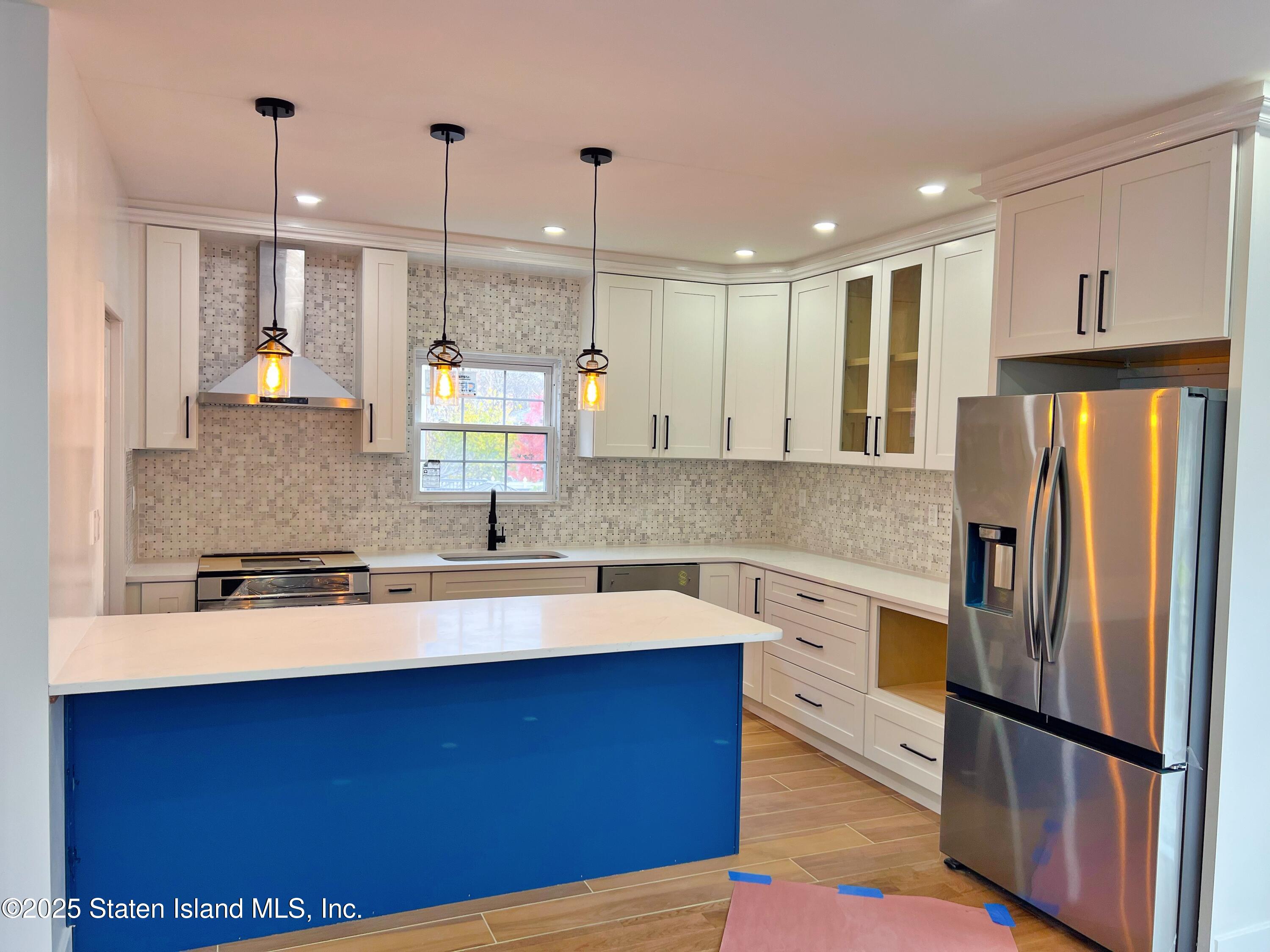 32 Remsen Street Staten Island, NY 10304 - Photo 10 of 41 a kitchen with stainless steel appliances granite countertop a refrigerator a sink dishwasher and a stove with wooden floor