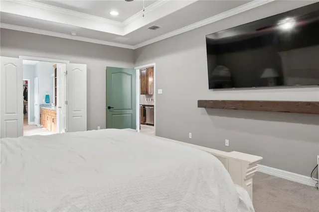 a bedroom with a bed and a television