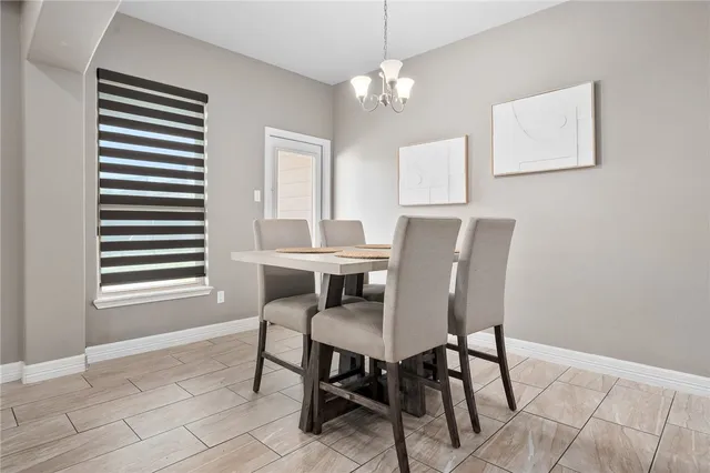 a view of a dining room with furniture and chandelier