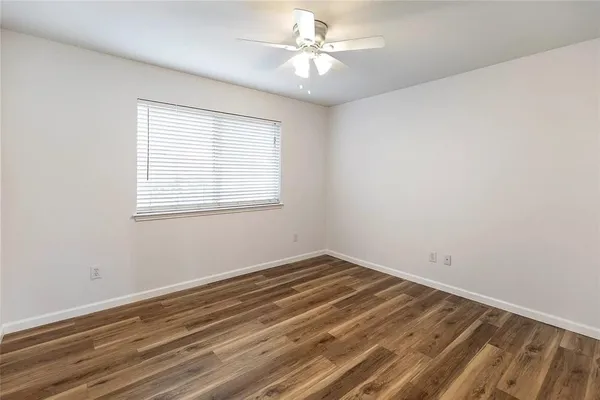 a view of a room with a window and a ceiling fan