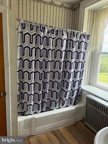 a view of a door and wooden floor