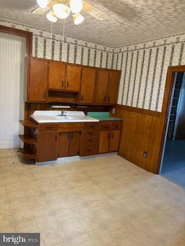 a view of kitchen with wooden cabinets