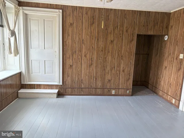 a view of front door with wooden floor