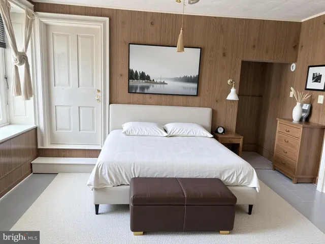 a bedroom with a bed and a painting on the wall