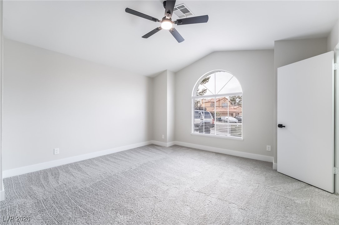 2850 Nikki Place Henderson, NV 89074 - Photo 16 of 64 Carpeted spare room featuring lofted ceiling and ceiling fan