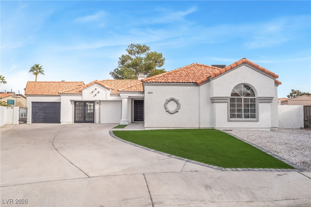 2850 Nikki Place Henderson, NV 89074 - Photo 2 of 64 Mediterranean / spanish-style home featuring a tile roof, stucco siding, driveway, and an attached garage