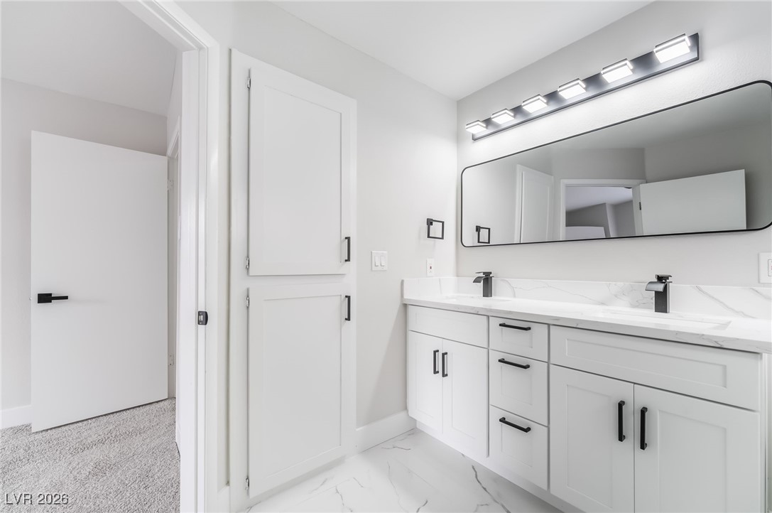 2850 Nikki Place Henderson, NV 89074 - Photo 22 of 64 Full bathroom with double vanity and light marble finish floors