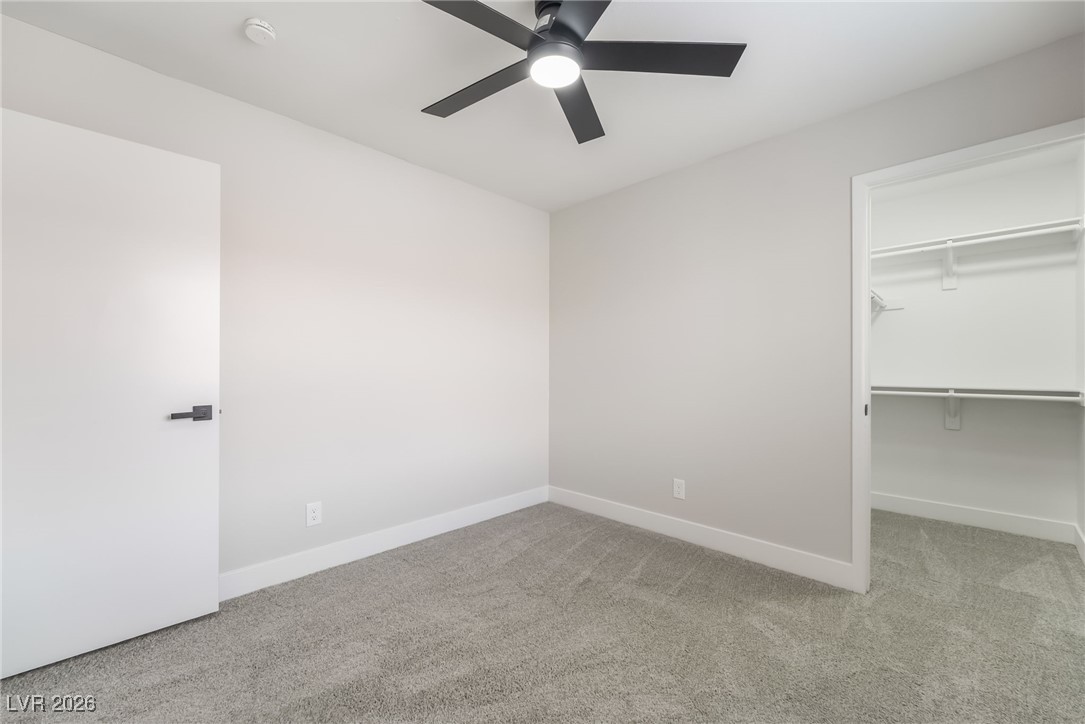 2850 Nikki Place Henderson, NV 89074 - Photo 24 of 64 Unfurnished bedroom featuring light carpet, a spacious closet, and ceiling fan