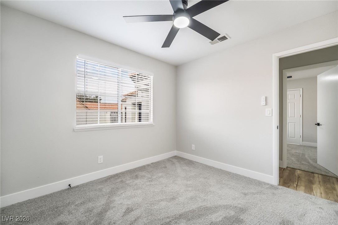 2850 Nikki Place Henderson, NV 89074 - Photo 25 of 64 Carpeted empty room featuring baseboards and ceiling fan