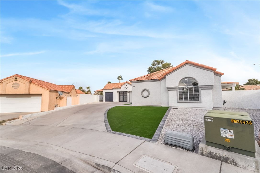 2850 Nikki Place Henderson, NV 89074 - Photo 3 of 64 Mediterranean / spanish house with a garage, a tiled roof, stucco siding, and concrete driveway