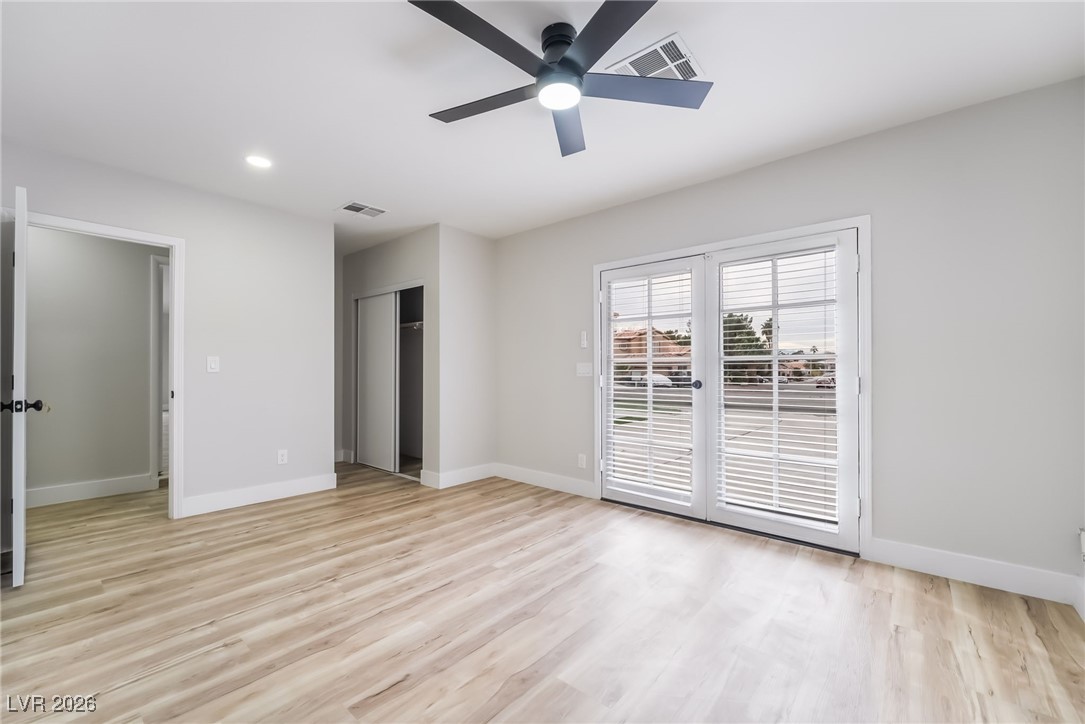 2850 Nikki Place Henderson, NV 89074 - Photo 32 of 64 Unfurnished bedroom featuring access to outside, light wood finished floors, a closet, recessed lighting, and a ceiling fan