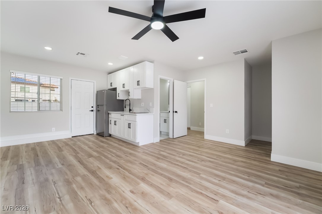 2850 Nikki Place Henderson, NV 89074 - Photo 33 of 64 Unfurnished living room featuring recessed lighting, light wood finished floors, and ceiling fan