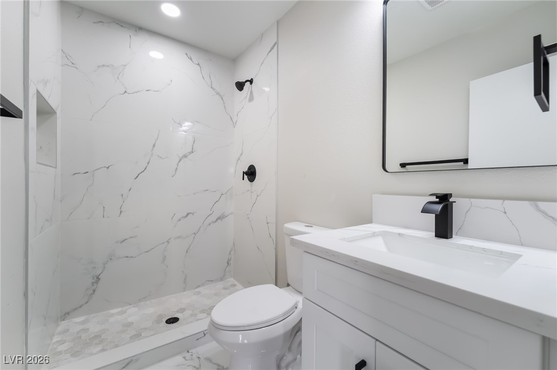 2850 Nikki Place Henderson, NV 89074 - Photo 36 of 64 Bathroom featuring vanity, a marble finish shower, marble finish flooring, and recessed lighting