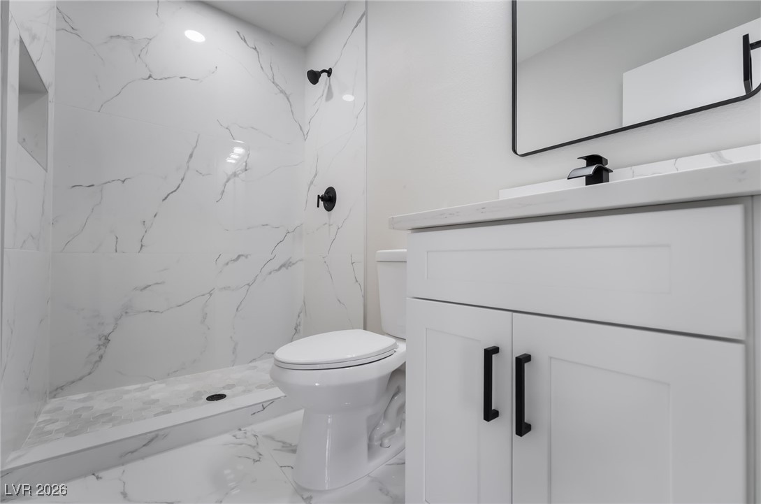 2850 Nikki Place Henderson, NV 89074 - Photo 37 of 64 Bathroom featuring vanity, a marble finish shower, and marble tiled floors