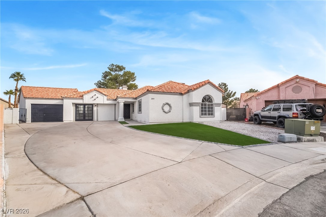 2850 Nikki Place Henderson, NV 89074 - Photo 4 of 64 Mediterranean / spanish-style house with a tiled roof, concrete driveway, stucco siding, and a garage