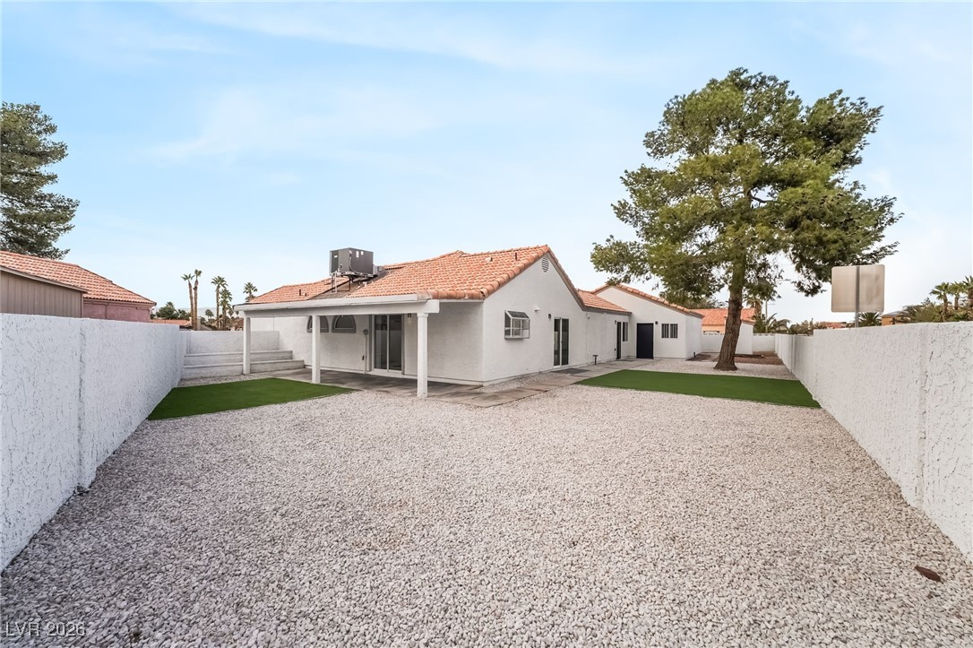 2850 Nikki Place Henderson, NV 89074 - Photo 42 of 64 Rear view of property featuring a patio area, a fenced backyard, stucco siding, and a tile roof