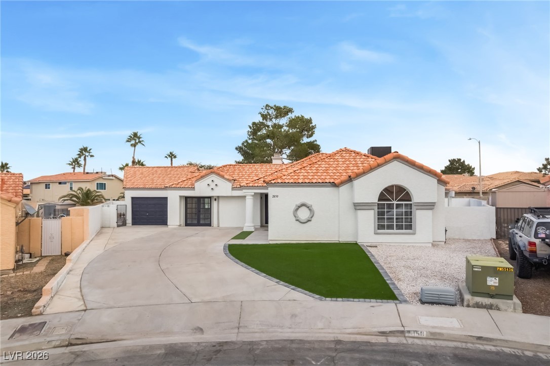 2850 Nikki Place Henderson, NV 89074 - Photo 45 of 64 Mediterranean / spanish home with a tiled roof, concrete driveway, and stucco siding