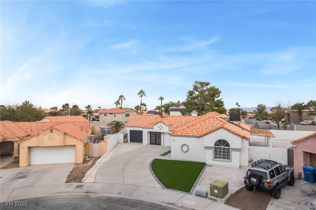 2850 Nikki Place Henderson, NV 89074 - Photo 46 of 64 Mediterranean / spanish home with concrete driveway, stucco siding, a tiled roof, a residential view, and a gate