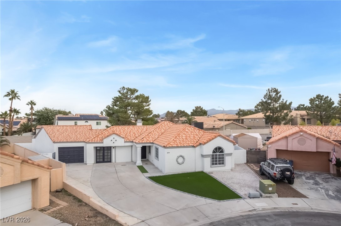 2850 Nikki Place Henderson, NV 89074 - Photo 48 of 64 Mediterranean / spanish-style house with stucco siding, a garage, a tiled roof, driveway, and a residential view