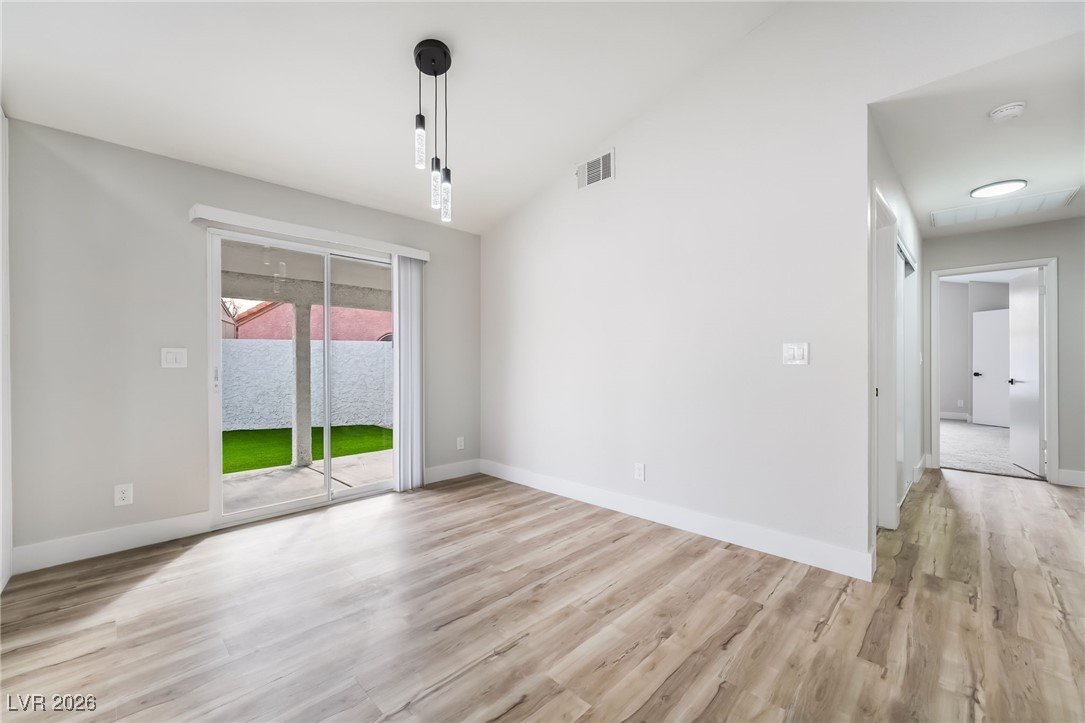 2850 Nikki Place Henderson, NV 89074 - Photo 10 of 64 Unfurnished dining area featuring lofted ceiling and light wood finished floors