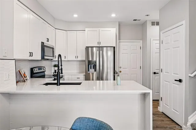 a kitchen with stainless steel appliances a refrigerator and a sink