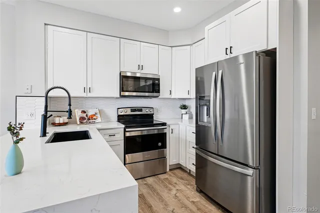 a kitchen with stainless steel appliances a refrigerator stove and microwave