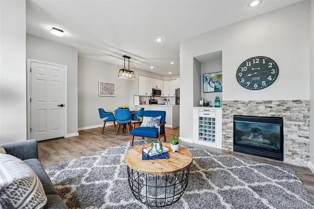 a living room with furniture a rug and a fireplace