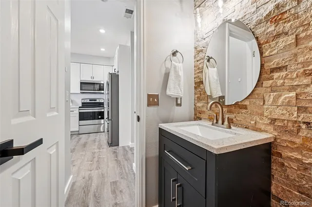 a bathroom with a sink vanity and a mirror