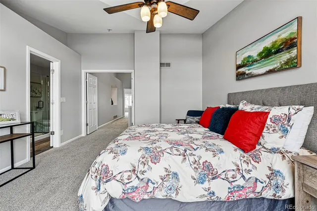 a bedroom with a bed and a painting on the wall